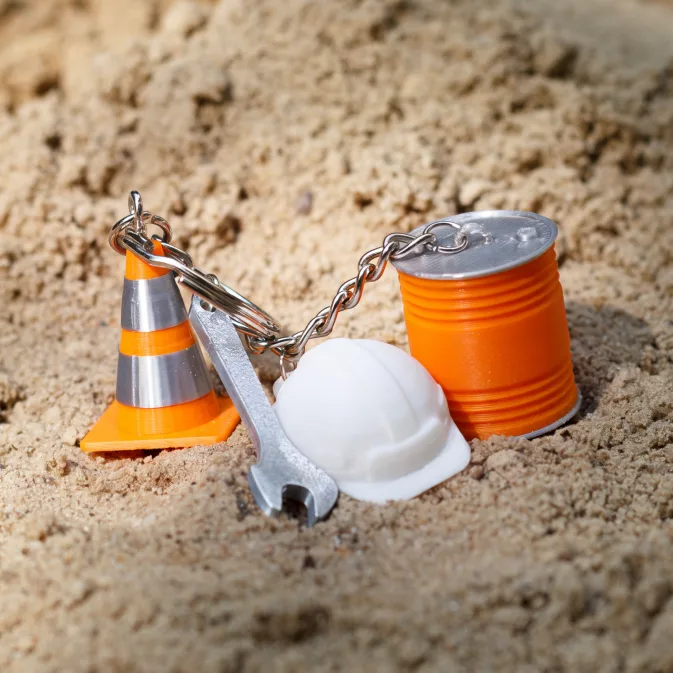 3D promotional keychains – a miniature traffic cone, helmet, spanner and paint can